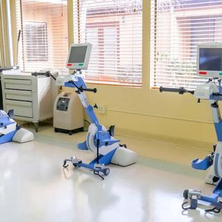 A rehabilitation room equipped with modern exercise machines for therapy.