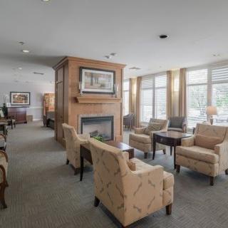 A bright lounge area with comfortable seating and a fireplace.