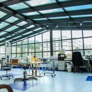 A modern office workspace featuring large windows and ample natural light.