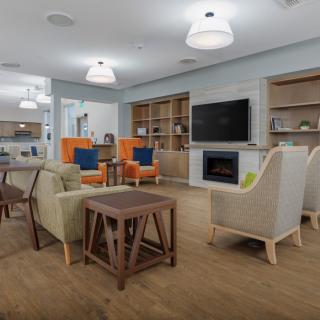A modern living room with comfortable seating, a TV, and a fireplace.