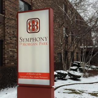A sign for Symphony Property Park surrounded by snow.