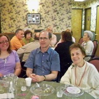 A group of people sitting at a table during a social gathering.