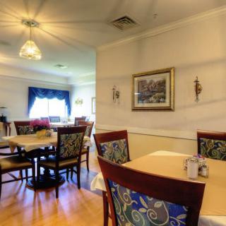 A cozy dining room with elegant decor and comfortable seating.