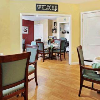 A cozy dining area with neatly arranged tables and chairs, featuring a welcoming atmosphere.