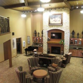 A spacious living room featuring a cozy fireplace, elegant seating, and warm lighting.