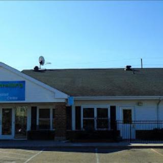 A commercial building with a clear blue sky in the background.