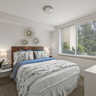 A cozy and modern bedroom featuring a comfortable bed, stylish decor, and ample natural light.