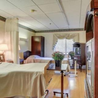 A well-equipped hospital room with two beds and medical equipment.