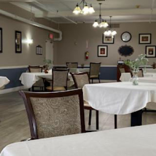 A spacious and elegantly set dining area, ready for guests.