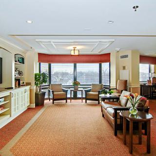 A well-lit lobby area with comfortable seating and large windows.