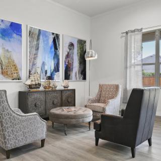 A cozy living room with stylish furniture and modern artwork on the walls.
