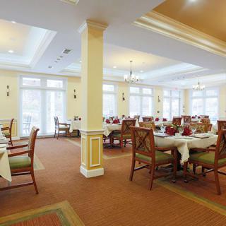 An elegantly decorated dining room with neatly arranged tables and chairs.