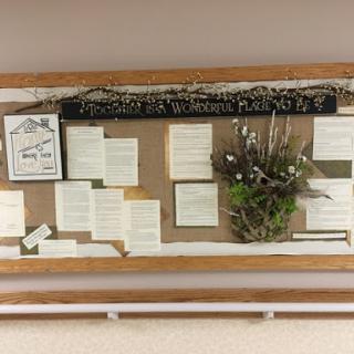 A creatively arranged bulletin board showcasing poetry and natural elements.