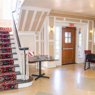 A beautifully designed lobby featuring an elegant staircase and inviting seating arrangements.