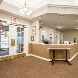 A welcoming office reception area with a desk and large doors.