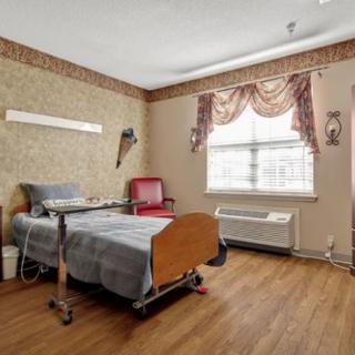 A hospital room with a patient bed and medical equipment.
