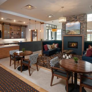 A modern living room with a cozy seating area and fireplace.