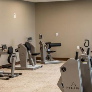 A gym room equipped with various fitness machines.