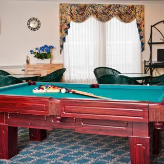 A cozy game room featuring a pool table with a classic design.