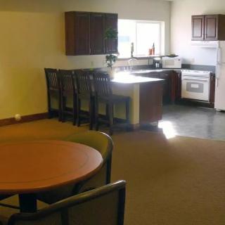 A cozy kitchen and dining area with a table, chairs, and modern appliances.