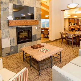 A modern living room with a cozy fireplace and stylish furniture.