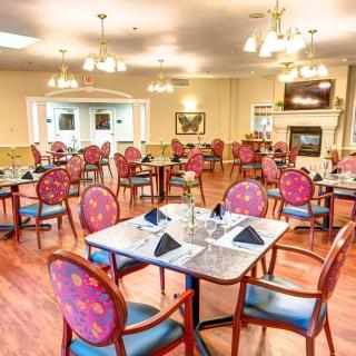 Elegant dining room with neatly arranged tables and chairs.