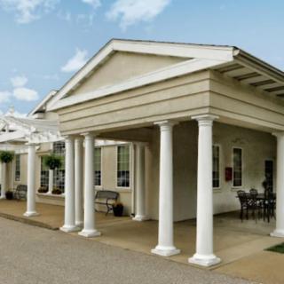A classical-style building with columns at the entrance.