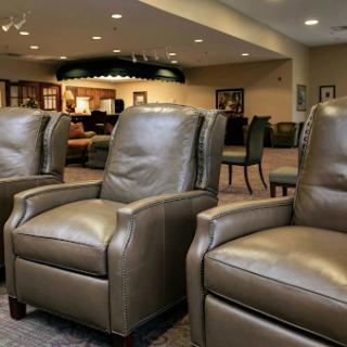 A row of comfortable leather recliners in a cozy lounge setting.