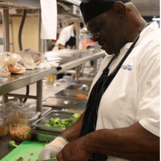 A chef in a commercial kitchen preparing food.