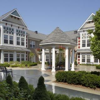 A charming residential building with landscaped gardens and a central courtyard.