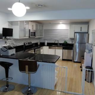 A modern kitchen with stainless steel appliances and a spacious countertop.
