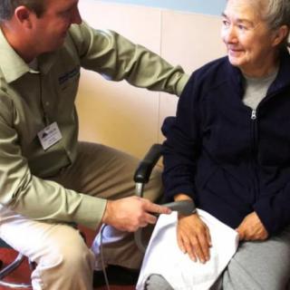 A healthcare professional conducting a check-up with an elderly patient.