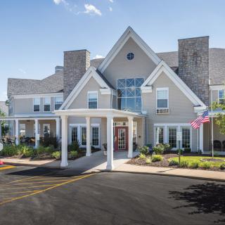 A large residential-style building with a welcoming entrance and manicured landscaping.