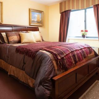 A cozy bedroom with warm colors and elegant decor.