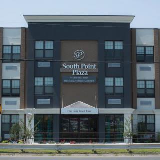 A modern hotel building with the name 'South Point Plaza' visible on the facade.