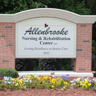 Sign for Allenbrooke Nursing & Rehabilitation Center surrounded by flowers.