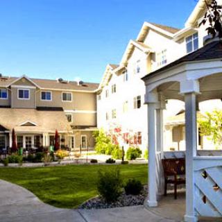 A picturesque view of a residential building featuring a well-maintained garden and inviting outdoor space.