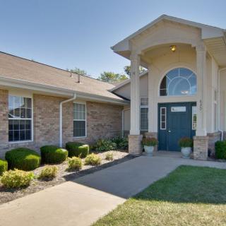 A well-maintained house with a grand entrance and manicured landscaping.