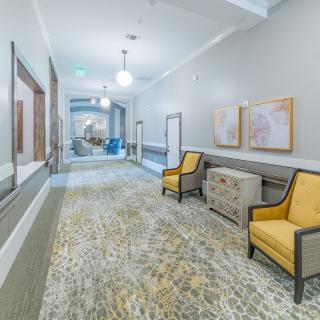 Bright and modern hallway with seating and decor.