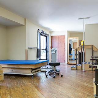 A spacious physical therapy room equipped with various rehabilitation tools.