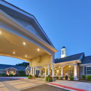 A well-lit building entrance during evening hours.
