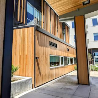 A contemporary building featuring a wooden facade and modern architectural elements.