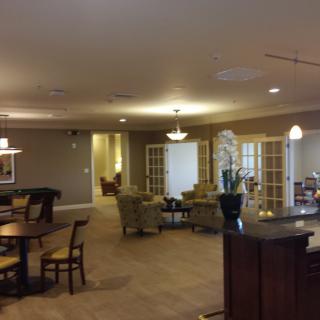 A spacious and well-furnished living area with seating arrangements and soft lighting.
