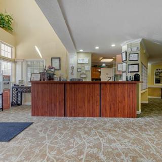 A view of a reception area with a front desk and surrounding office furnishings.