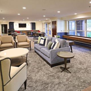 A modern living room with comfortable seating and large windows.
