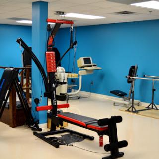 A well-equipped gym area featuring various fitness machines and exercise equipment.