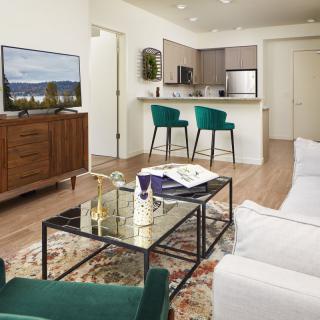 A modern open-concept living room and kitchen with stylish furniture and decor.