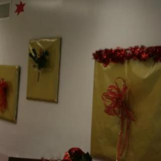 Festive wall decorations featuring wrapped frames and ribbons.