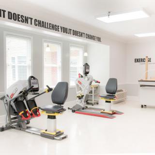 A bright and modern gym with various exercise machines ready for use.
