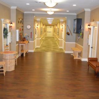A spacious, well-lit hallway in a care facility or residential building.
